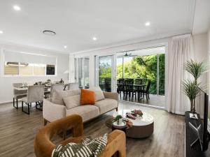 a living room with a couch and a table at Spacious 4-Bedroom Bardon Retreat Across 2 Levels in Brisbane