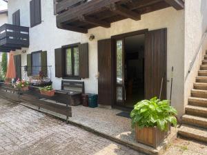 a front door of a house with potted plants at EmilyNest in Vervò +9 photos