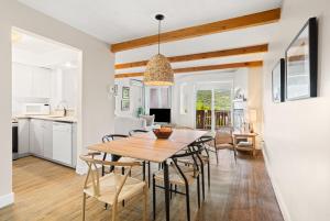 a kitchen and dining room with a wooden table and chairs at Stunning One-Bedroom Condo With Lake View in Mont-Tremblant