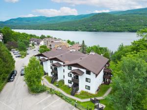 an aerial view of a large house with a lake at Stunning One-Bedroom Condo With Lake View in Mont-Tremblant