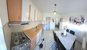 a kitchen with a stove and a counter top at Apartman BELLA in Doboj