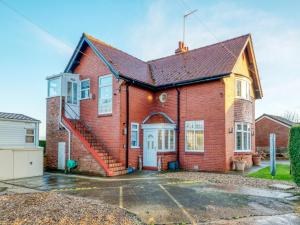 una casa de ladrillo rojo con garaje en 1 bed in Filey 77709, en Hunmanby