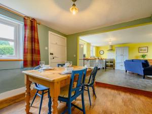 a dining room and living room with a table and chairs at 2 Bed in Egremont 87227 in Egremont +14 photos