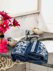 a blue and white towel sitting on a sink at AnaLena Do Mar in Búzios