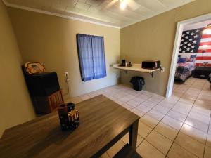 an empty living room with a table and a table sidx sidx sidx at Hill Country Lodge and Mini Storages in Buchanan Dam