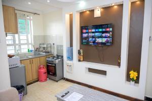 a kitchen with a drink dispenser on the wall at SpringStone executive STUDIO apartment A19 in Ongata Rongai 