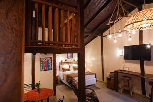 a bedroom with a loft bed and a tv in a room at Chalés Terraviva in Pirenópolis