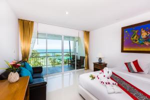 a room with a bed and a couch and a balcony at Lamai Coconut Beach Resort in Lamai +37 photos