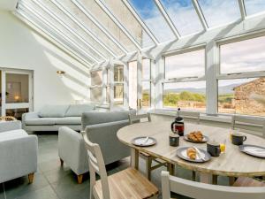 a living room with a table and chairs at 8 bed in Cockermouth 82453 in Bridekirk