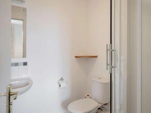 a white bathroom with a toilet and a sink at 8 bed in Cockermouth 82453 in Bridekirk +18 photos