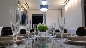 a long table with plates and glasses on it at Palm Village Acqua in Porto De Galinhas
