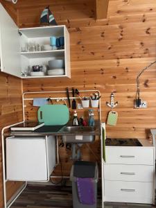 a kitchen with a counter and a sink in a room at Błękitna Przystań Pobierowo in Pobierowo