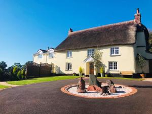 a house with a fountain in the middle of a street at 2 Bed in Tiverton 51275 in Stockleigh Pomeroy