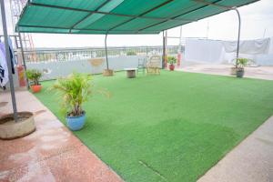 a patio with green grass and a large tent at SpringStone executive apartment A10 in Ongata Rongai 