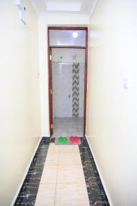 a hallway with a shower and a tile floor at SpringStone executive apartment A10 in Ongata Rongai  +8 photos