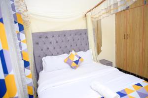 a bedroom with a bed with a canopy at SpringStone executive apartment A10 in Ongata Rongai 