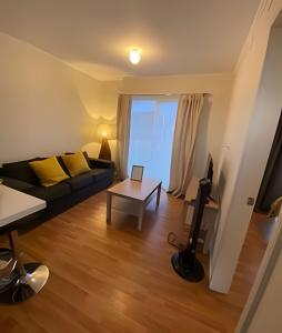 a living room with a couch and a table at Lindas y acogedoras cabañas en puerto varas. in Puerto Chico +58 photos