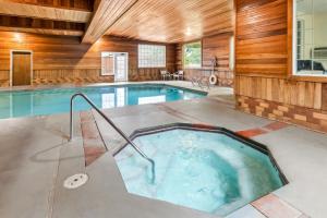 a swimming pool in a house with a wooden wall at Comfort Suites Clackamas in Clackamas