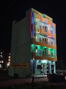 a building with colorful lights on it at night at Murugavel Residency in Vishāram