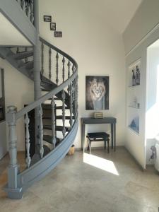 a staircase in a living room with a table at Charming & cosy duplex in city center in Luxembourg