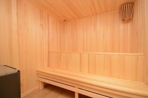 a sauna with a wooden bench in a room at Dilijan Aqualin Villa - Heated pool, sauna and panoramic views in Dilijan