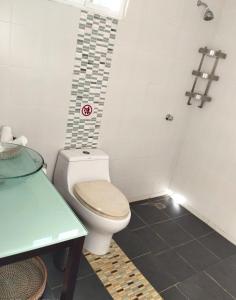 a small bathroom with a toilet and a table at Family Villa in Las Galeras, Samaná in Las Galeras +24 photos