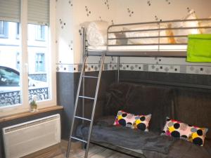 a living room with a bunk bed and a couch at Studio MARMOTTES au RDC a HYPER centre du Mont DORE in Mont-Dore