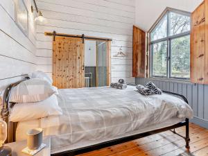 a bedroom with a bed in a room with wooden walls at 2 Bed in Pantygelli BN246 in Abergavenny