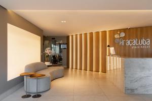 a lobby with a chair and a table at Araçatuba Plaza Hotel in Araçatuba +231 photos