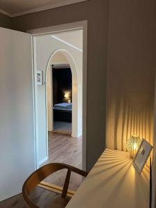 a bedroom with a bed and a table with a lamp at Fonnagata in Åndalsnes