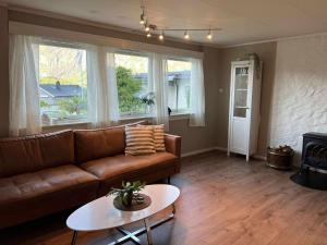 a living room with a couch and a table at Fonnagata in Åndalsnes +1 photo
