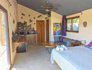 a bedroom with a bed and a table and a couch at Colina Escondida: monoAmbiente in San Juan del Sur