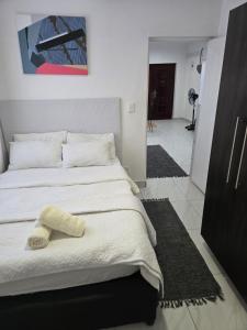 a bedroom with a bed with a towel on it at Oasiselfcatering guest house in Kimberley +14 photos