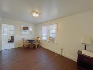 a living room with a table and chairs and a kitchen at Shore Beach Houses - 38 B Lincoln Ave in Seaside Heights