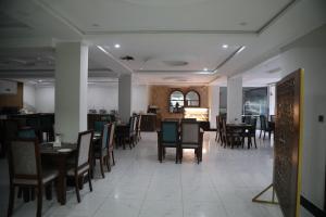 a dining room with tables and chairs in a restaurant at Skyline Chairlift View - Patriata New Murree by LMY in Patriata