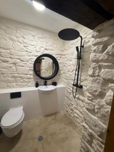 a bathroom with a toilet and a mirror on the wall at Stylish Industrial 1 Bed in Bristol