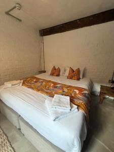 a bedroom with a bed with a blanket on it at Stylish Industrial 1 Bed in Bristol +15 photos