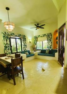 a living room with a couch and a table at Casa Rosa Paradise in Puerto Escondido +33 photos