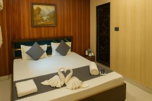 Voodi või voodid majutusasutuse Ramayana Grand Hotel Ayodhya toas
