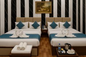 Voodi või voodid majutusasutuse Ramayana Grand Hotel Ayodhya toas