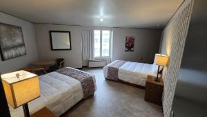 a hotel room with two beds and a table at Smartwood Inn in Osseo