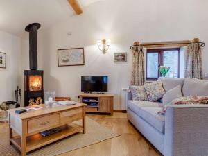 a living room with a couch and a wood stove at 1 Bed in Glastonbury 60295 in Ashcott