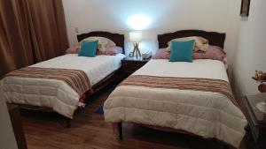 two beds in a hotel room with two pillows at New house with pool, excellent, 3 bedrooms in Pazulco +25 photos