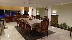 a dining table and chairs in a living room at New house with pool, excellent, 3 bedrooms in Pazulco