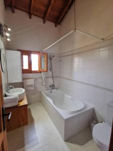 a bathroom with a tub and a sink and a toilet at Wedding Unique Villa in Larnaka +3 photos