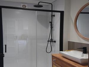 a bathroom with a shower and a sink and a mirror at 4 Bed in Bexhill on Sea 77602 in Bexhill