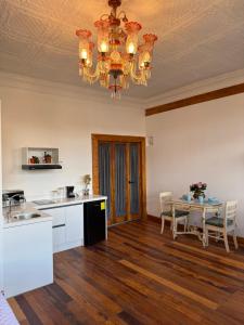 a kitchen with a dining table and a chandelier at Casa Vega in Cuenca