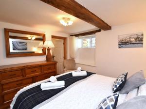 a bedroom with a large bed with towels on it at 1 Bed in Richmond 44401 in Reeth