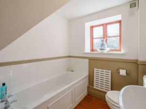 a bathroom with a tub and a toilet and a window at 1 Bed in Richmond 44401 in Reeth +32 photos
