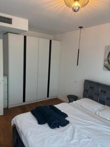 a bedroom with a bed with a blue blanket on it at Aviatiei-Boutique in Bucharest